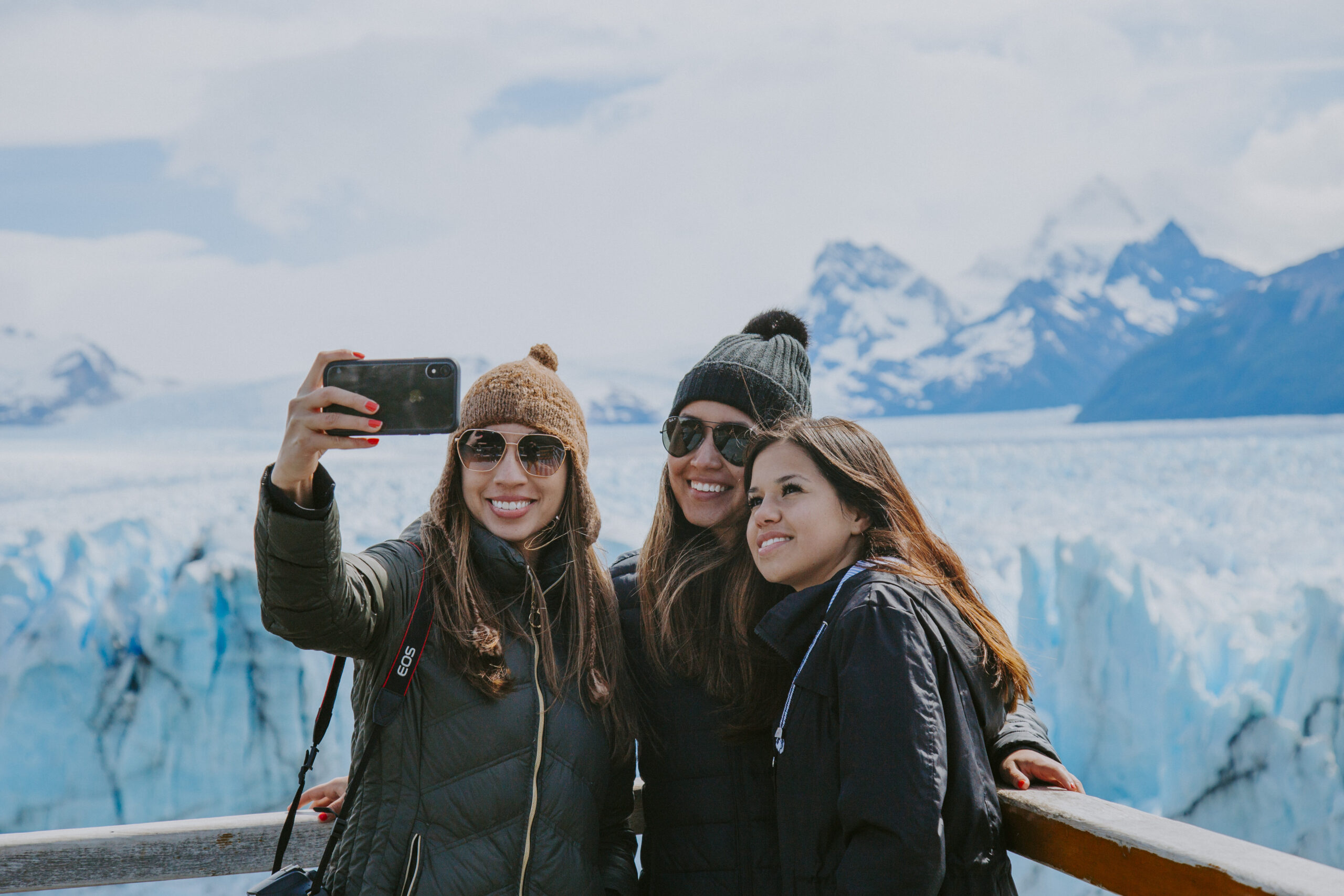 three-millennial-girl-friends-taking-selfies-on-a-2022-11-07-21-39-21-utc